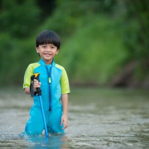 a boy playing in a river