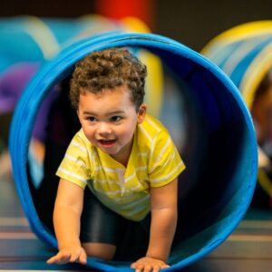 a child playing in a play tube