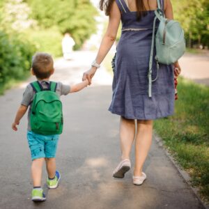 a mother and child walking to school