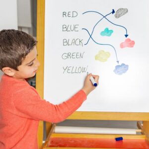 a child matching words to colors on a whiteboard