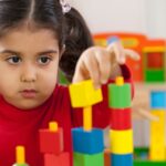a child building with blocks