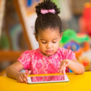 a preschooler working on a tablet